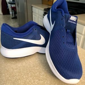 Blue Mens size 9 Nike Revolution 4 running shoes.